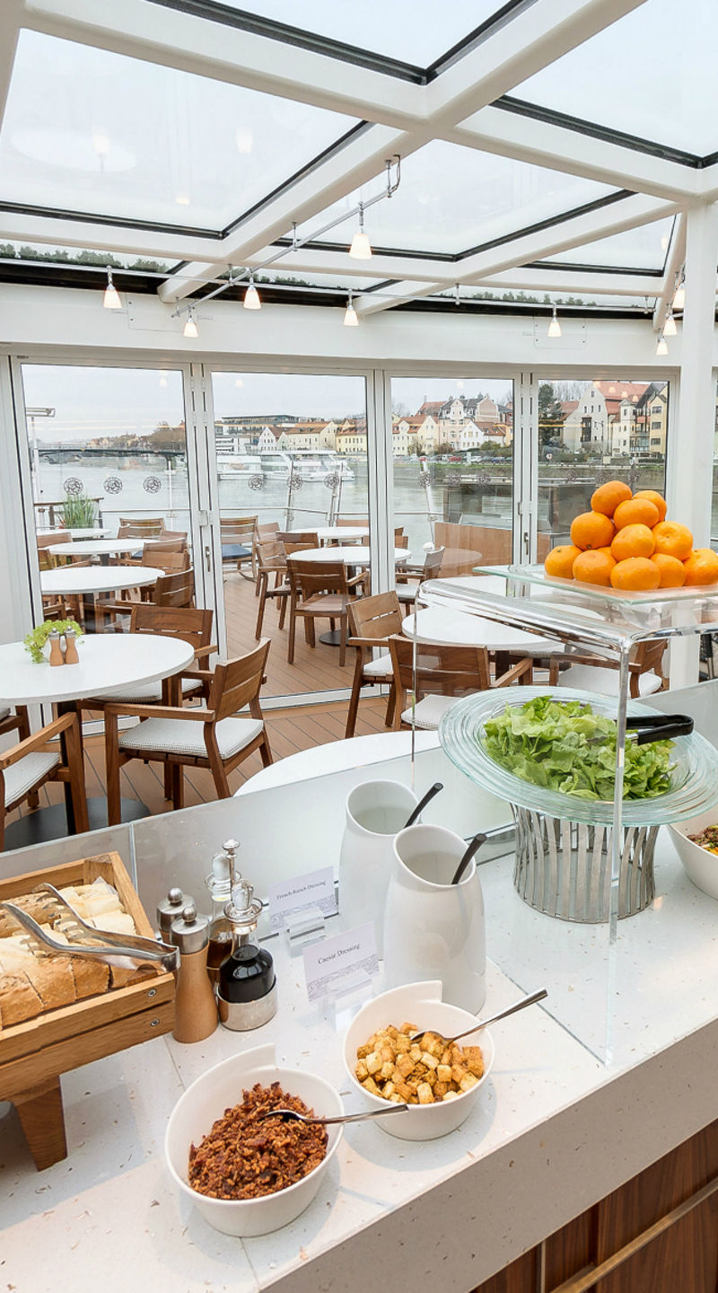Modern riverside dining area with buffet setup