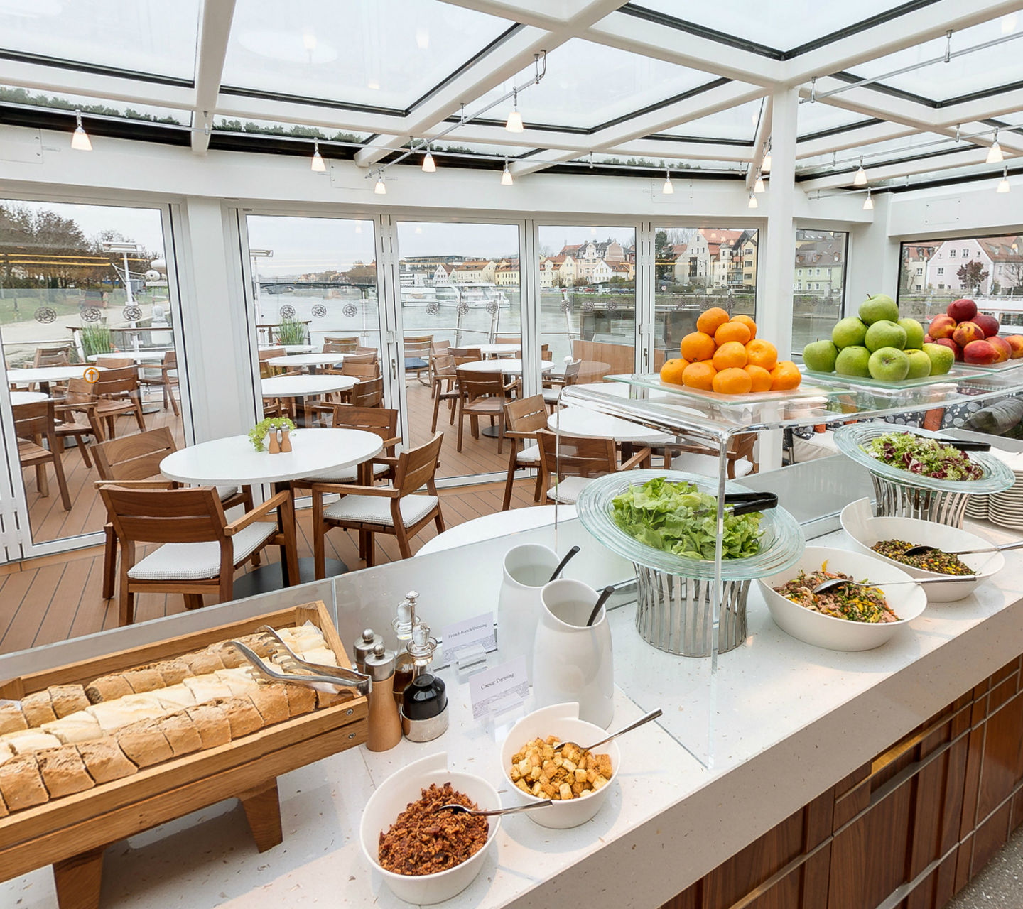 Modern riverside dining area with buffet setup