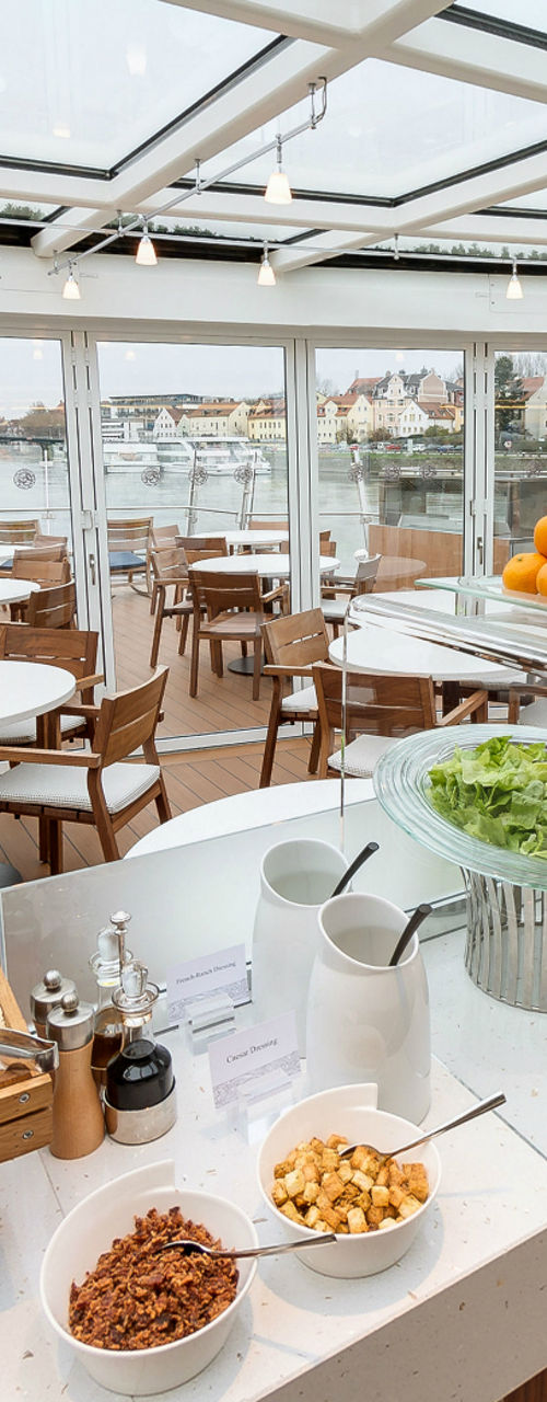 Modern riverside dining area with buffet setup