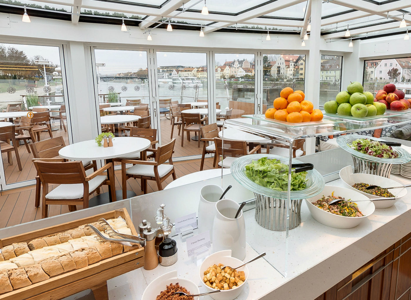 Modern riverside dining area with buffet setup
