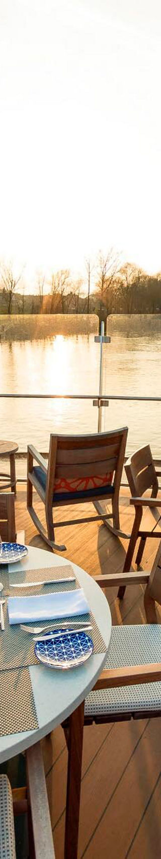 Outdoor dining setup by serene riverside