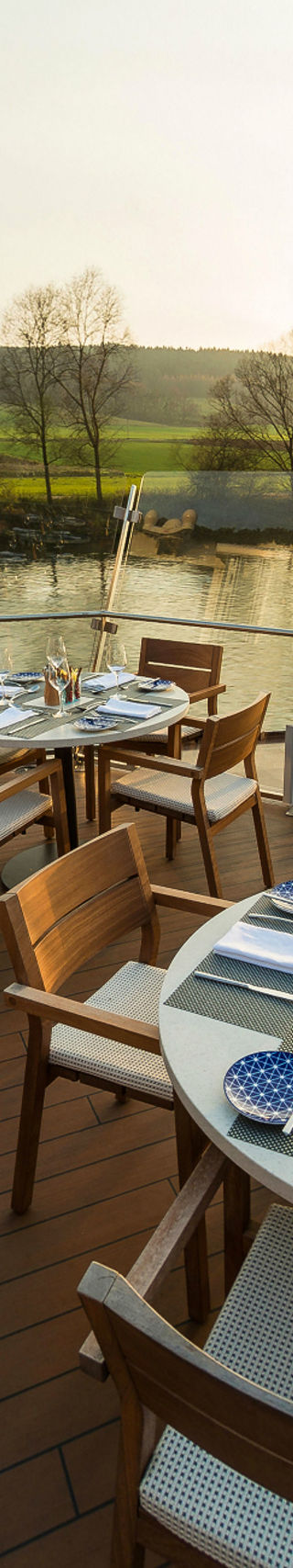Outdoor riverside dining with scenic views