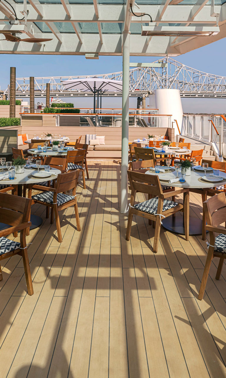 Riverside outdoor dining with bridge view