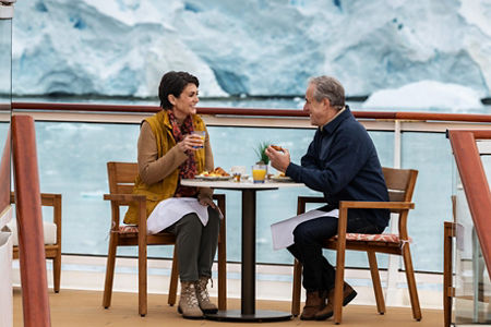 Couple dining outdoors with glacier view