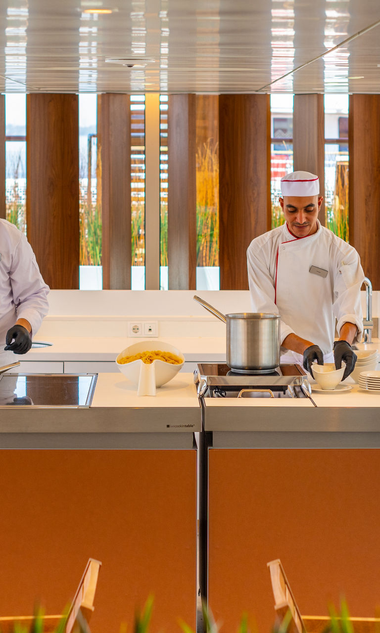 Chefs preparing food in modern outdoor kitchen