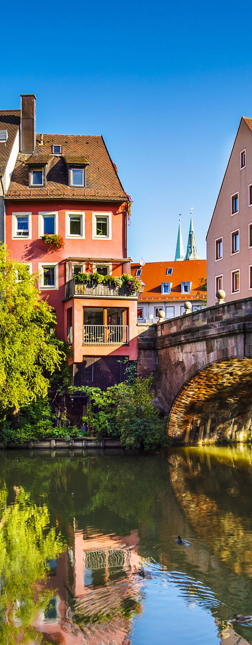 Historic bridge and colorful riverside buildings