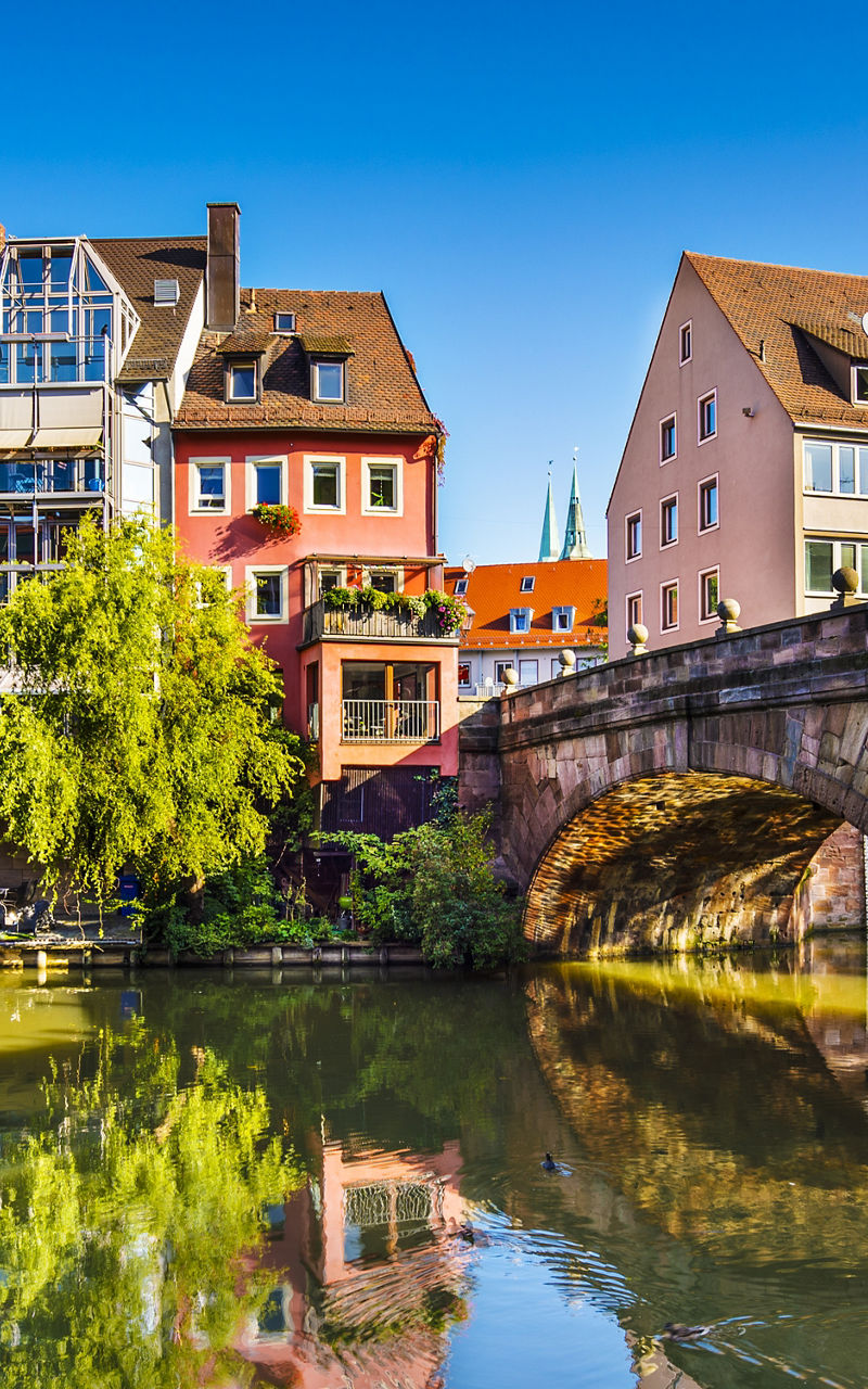 Historic bridge and colorful riverside buildings