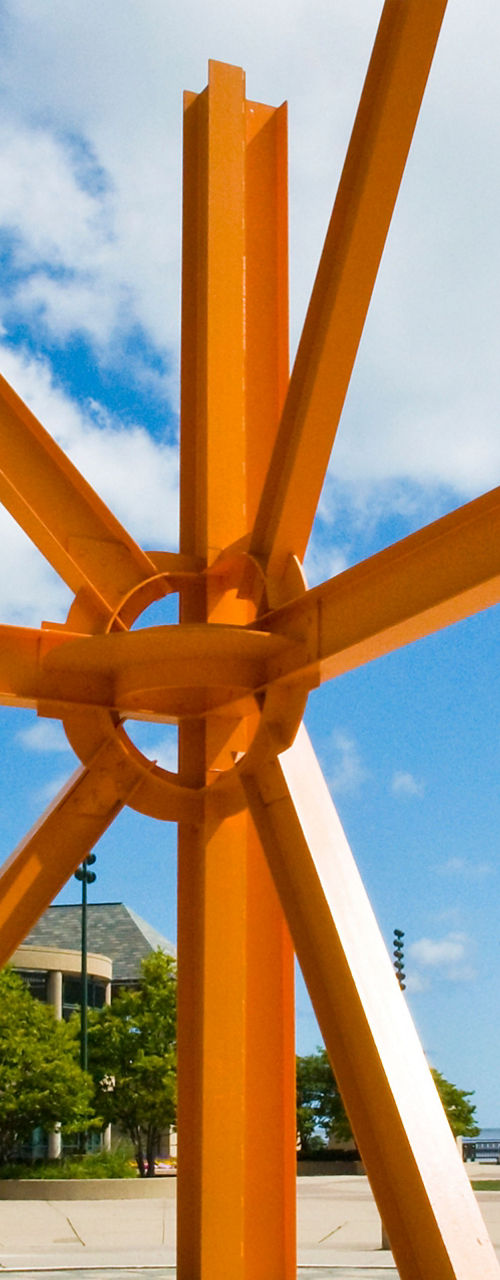 Bright orange sculpture in outdoor plaza
