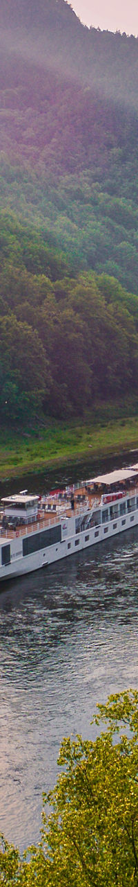 Scenic river cruise at sunset in lush valley