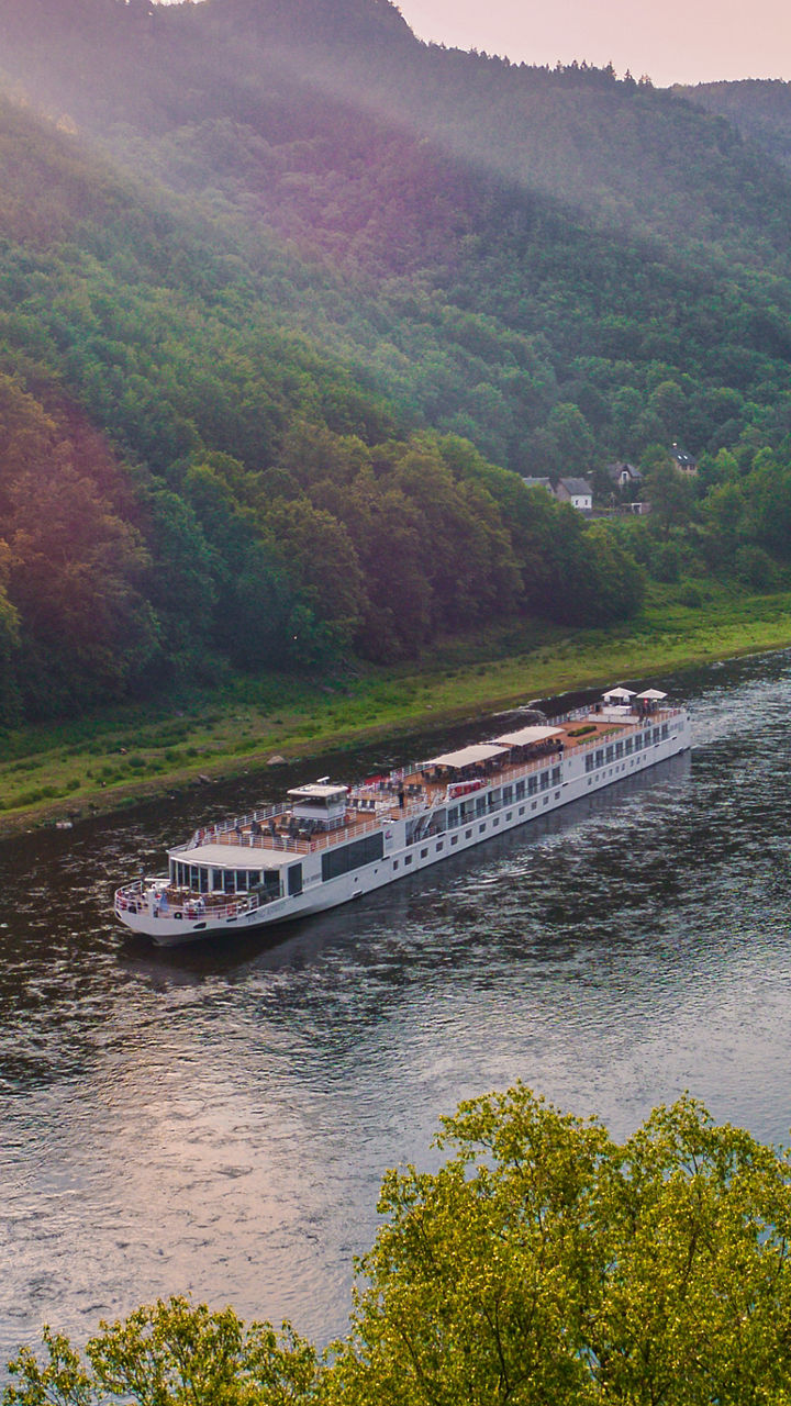 Scenic river cruise at sunset in lush valley