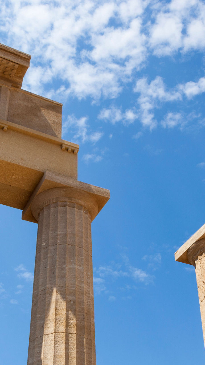 Ancient Greek columns under blue sky