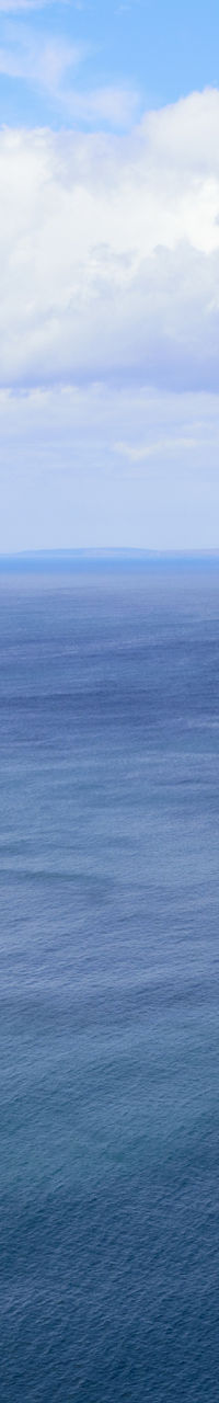 Calm open ocean under cloudy sky