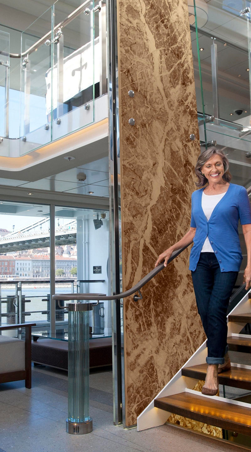 Two women walking down elegant staircase