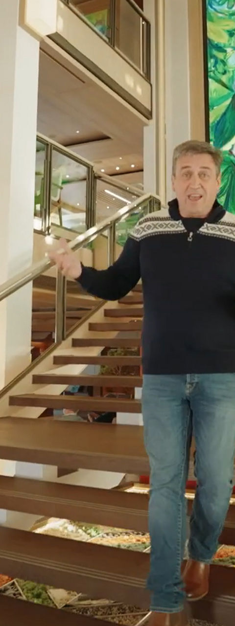 Man Descending Grand Staircase in Modern Atrium