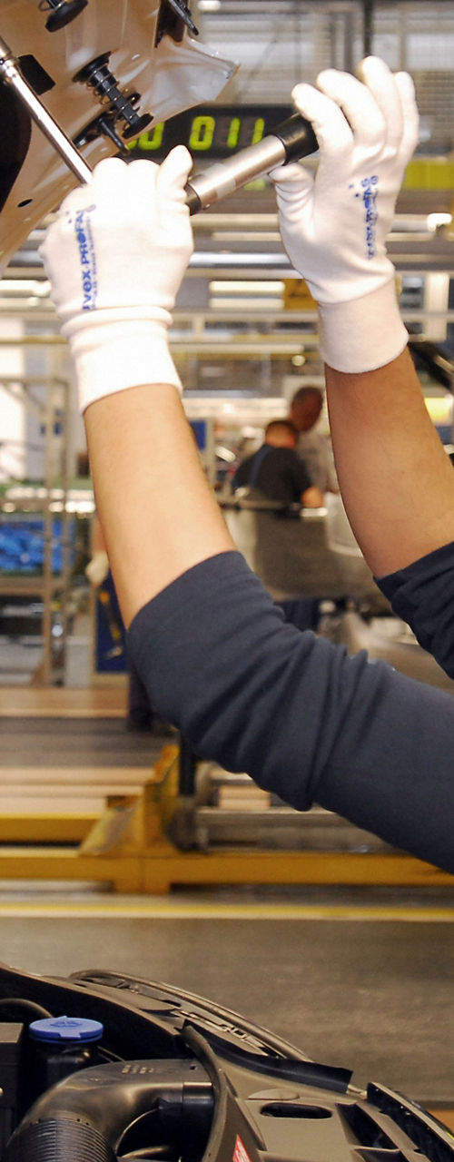 Worker inspecting car assembly line