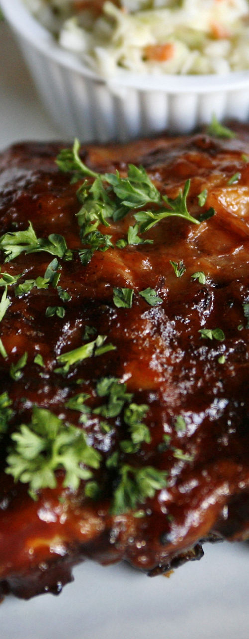 Barbecue ribs with sides on white plate
