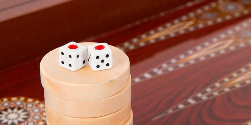 Dice on stacked wooden game pieces