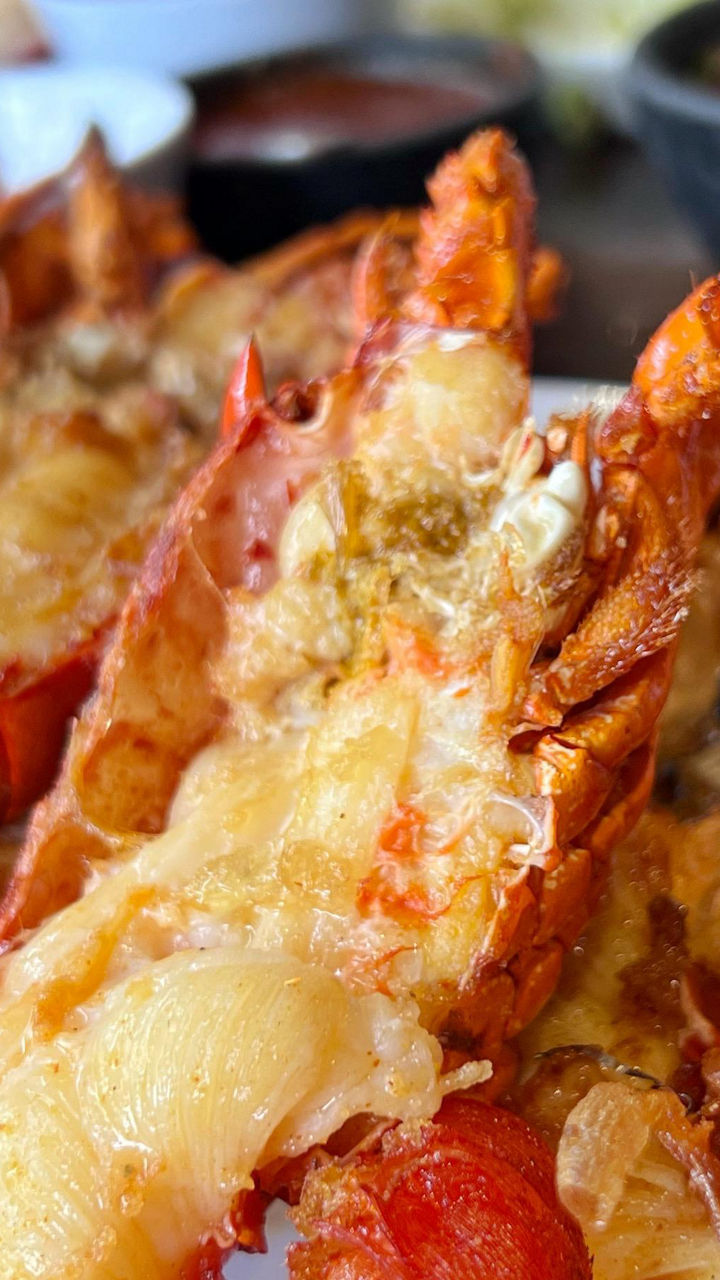 Grilled lobster tails served on a white plate