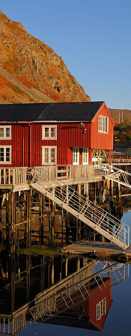 Red waterfront cabins in scenic harbor