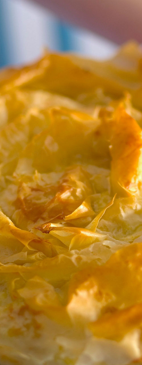 Freshly baked golden pie on checkered cloth