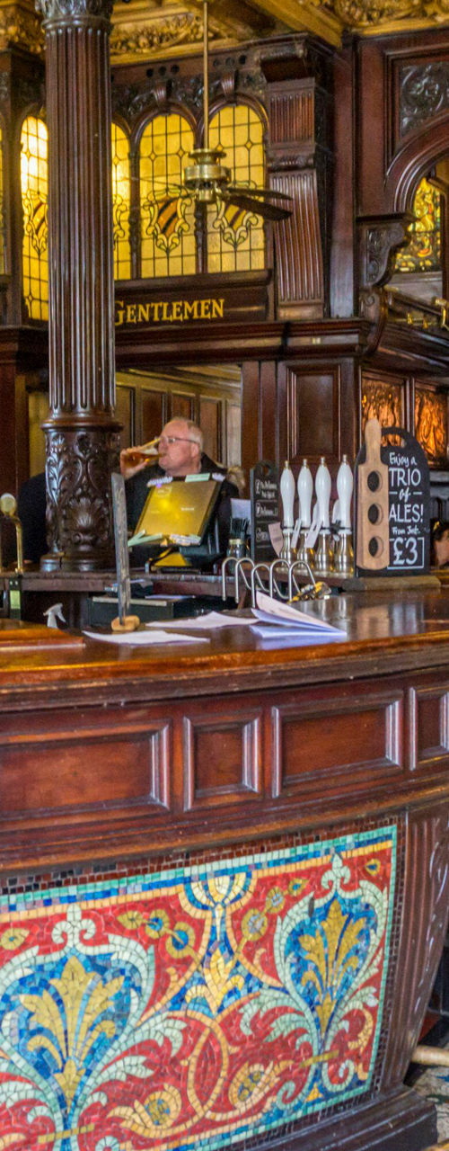 Traditional pub interior with ornate wooden bar