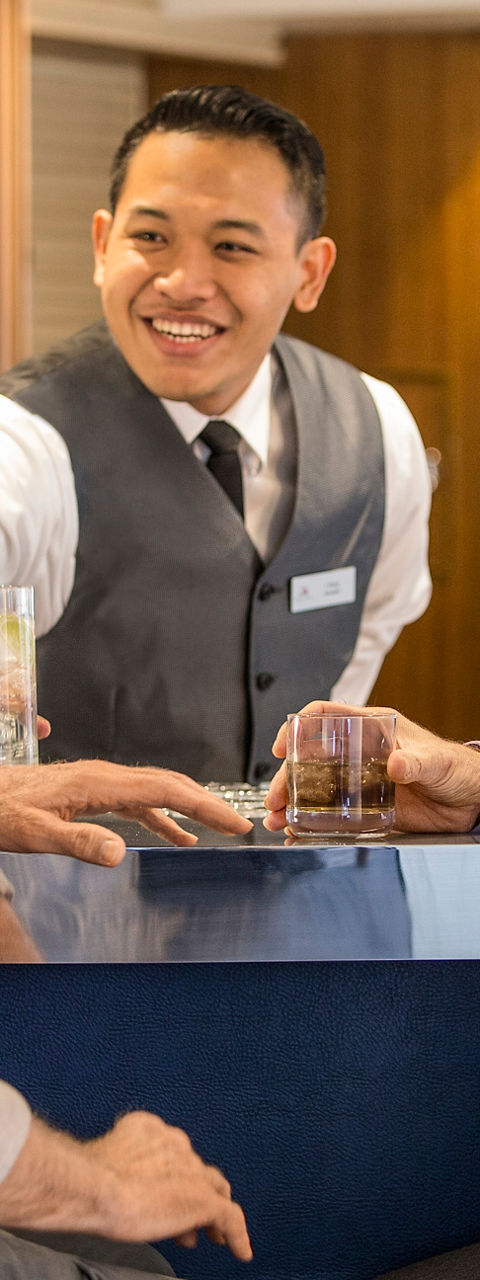 Two men enjoying drinks at a bar
