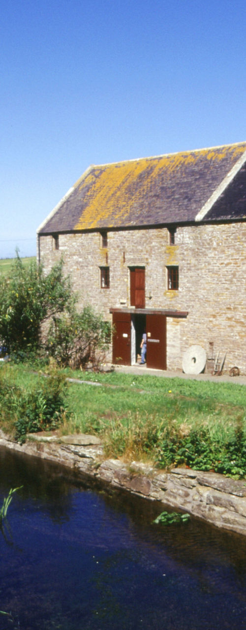 Rustic stone farmhouse by a stream