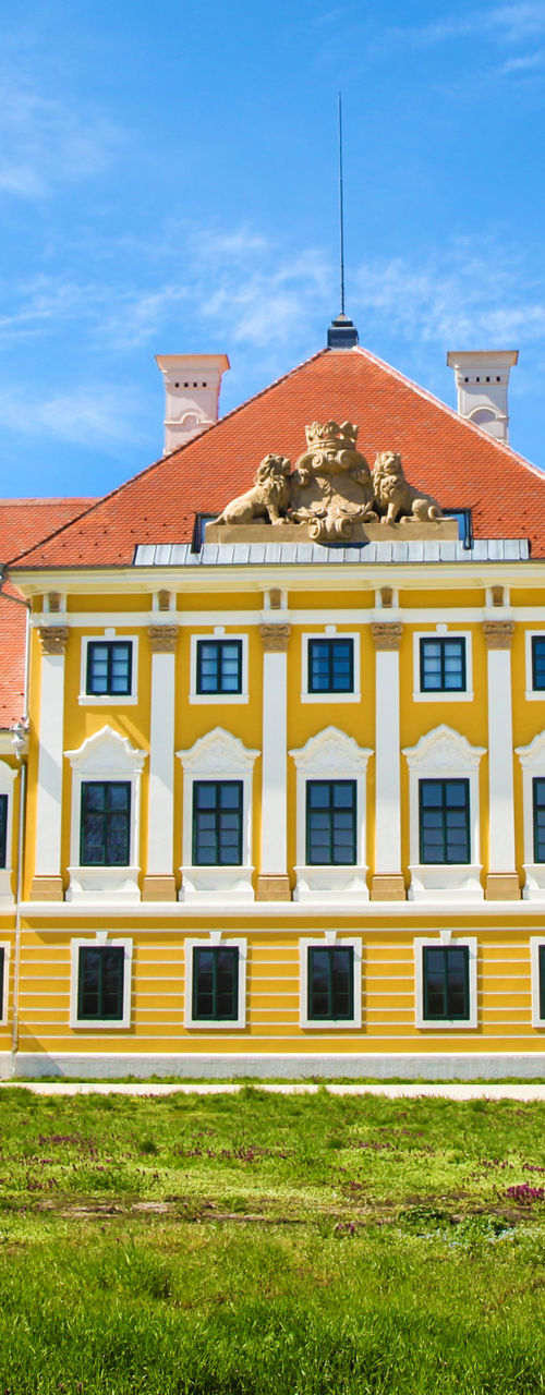Historic yellow mansion with red roof