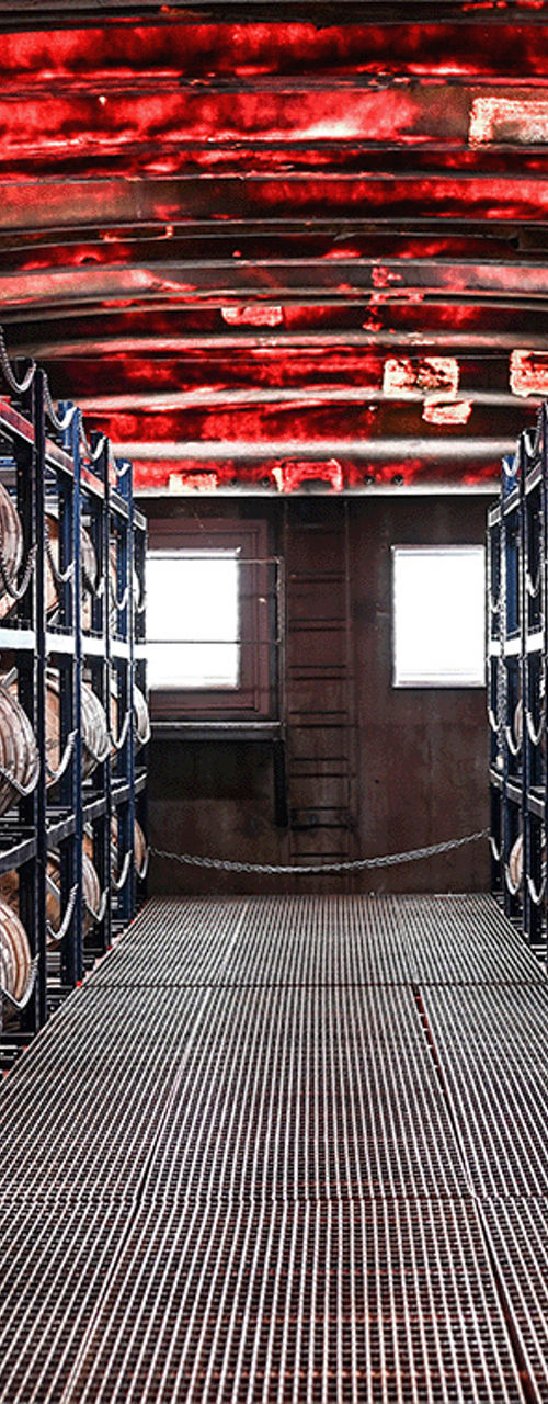 Aged Wooden Barrels in Industrial Warehouse Interior