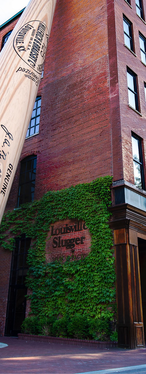 Giant baseball bat outside brick building
