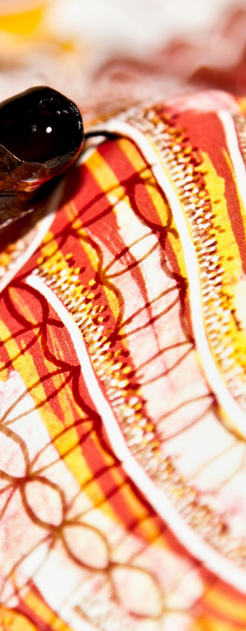 Hand applying wax on colorful fabric