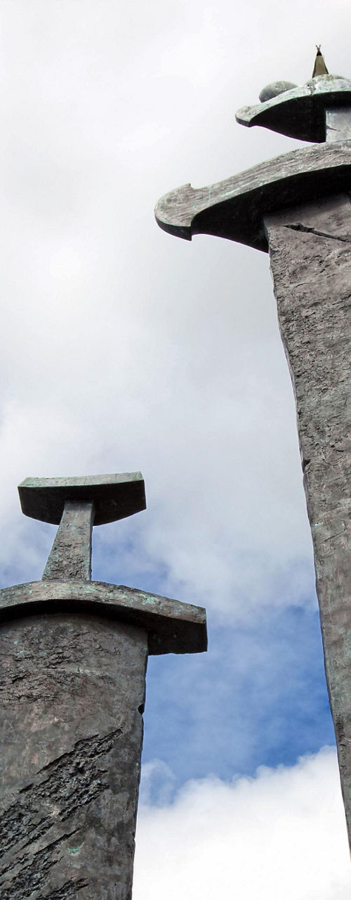 Three Viking swords monument under blue sky