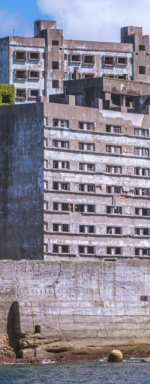 Abandoned Concrete Buildings on Island Shoreline