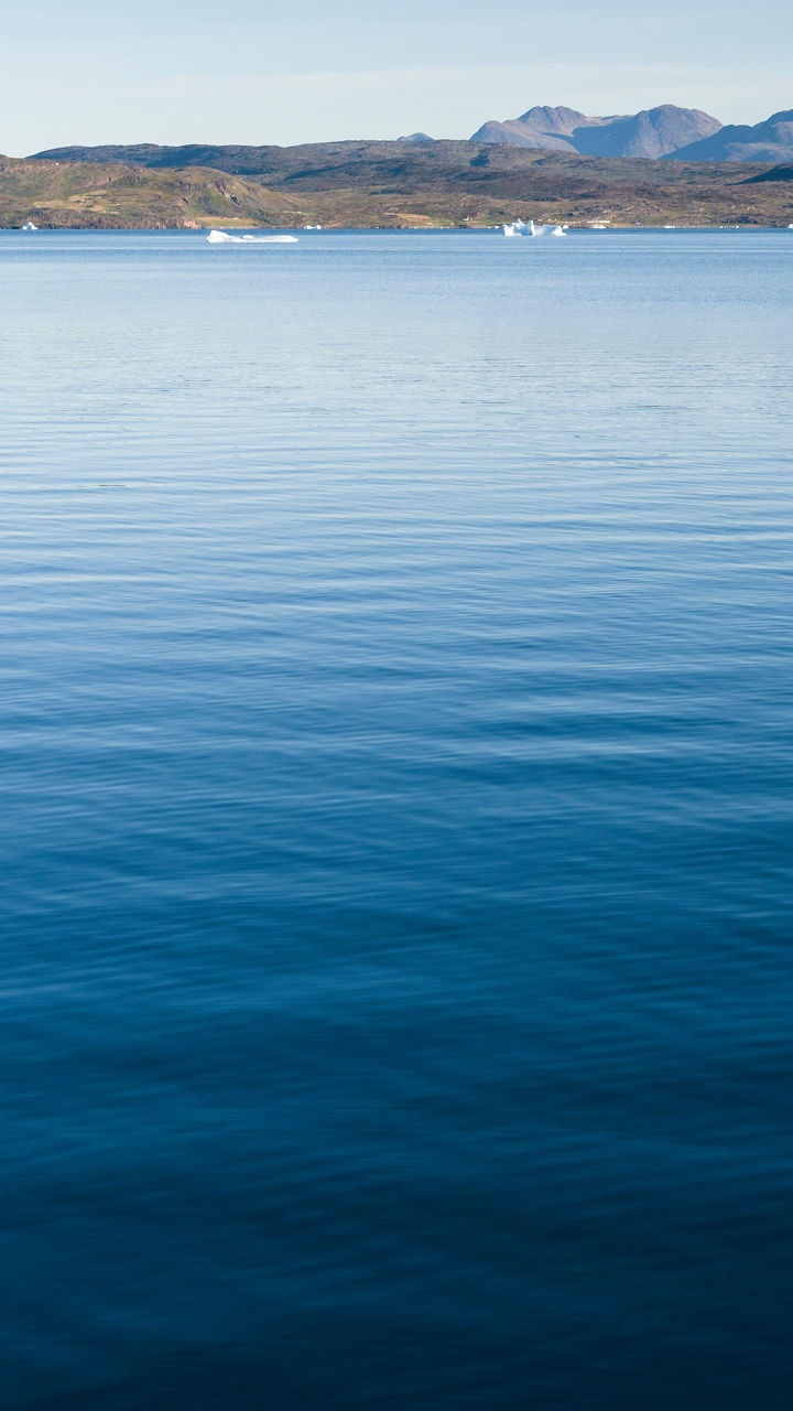 Serene lake with distant mountains