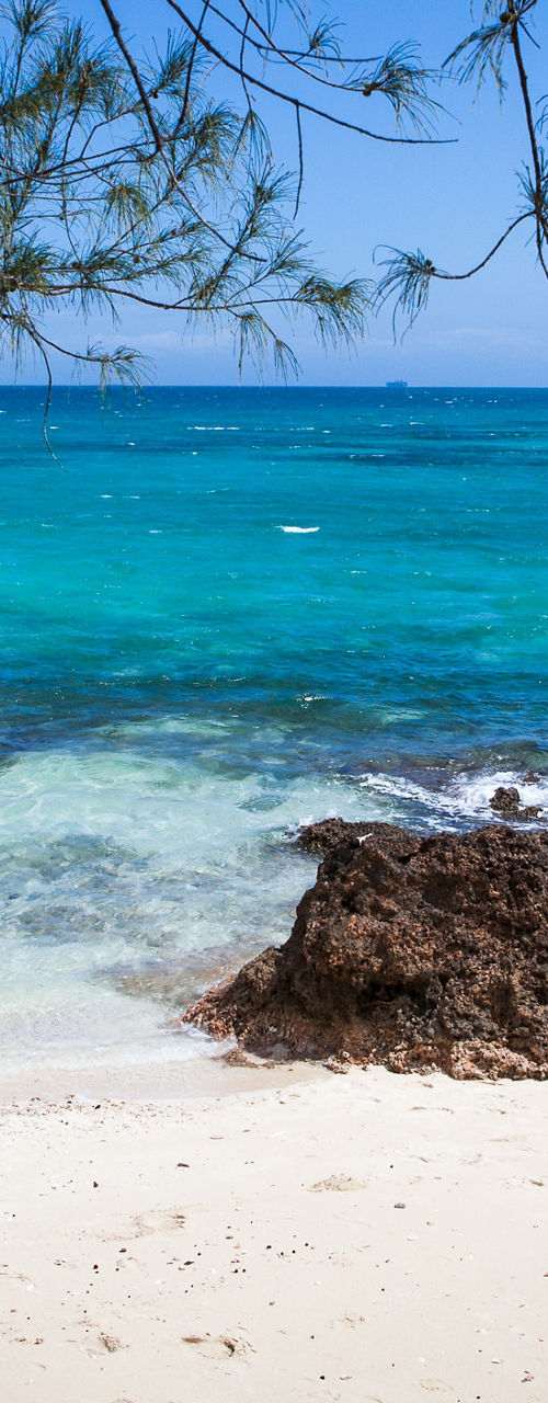 Tropical beach with turquoise waters and rocks