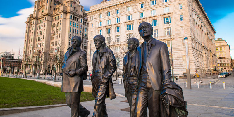 Liverpool Beatles statues near iconic buildings