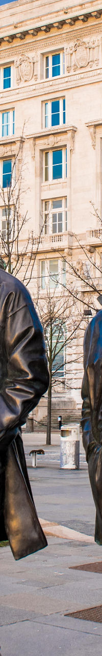 Liverpool Beatles statues near iconic buildings