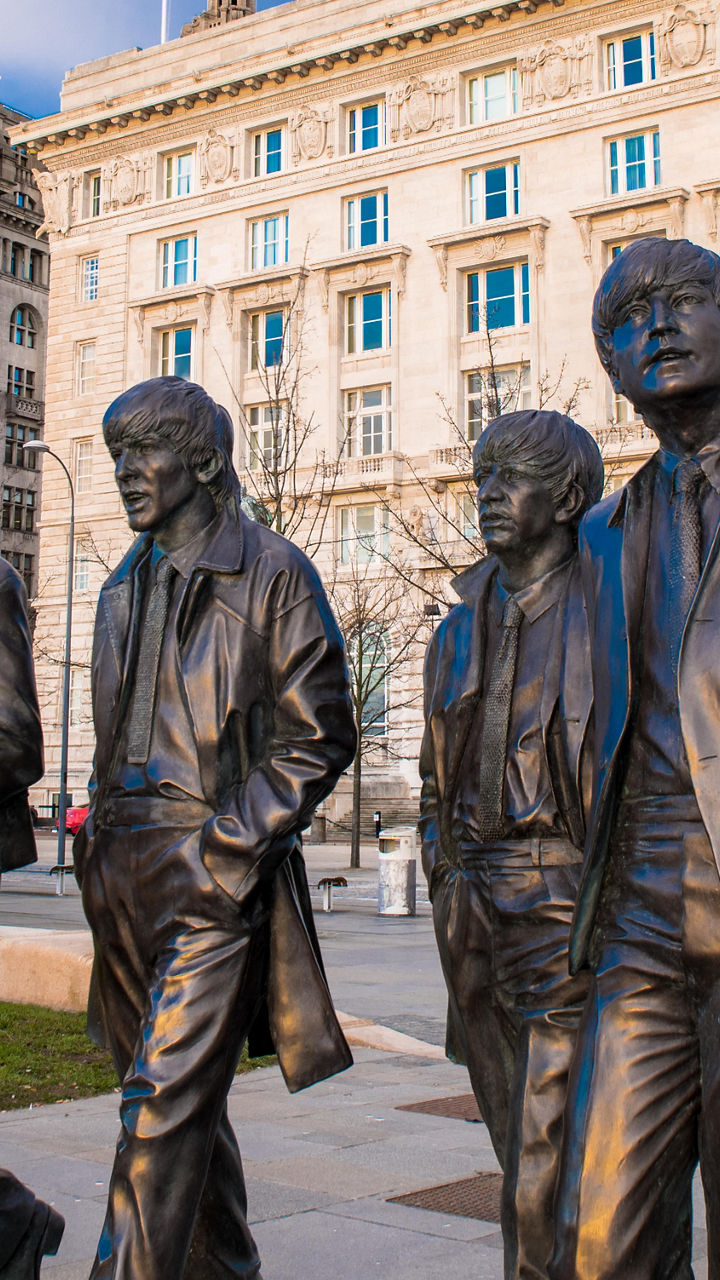Liverpool Beatles statues near iconic buildings