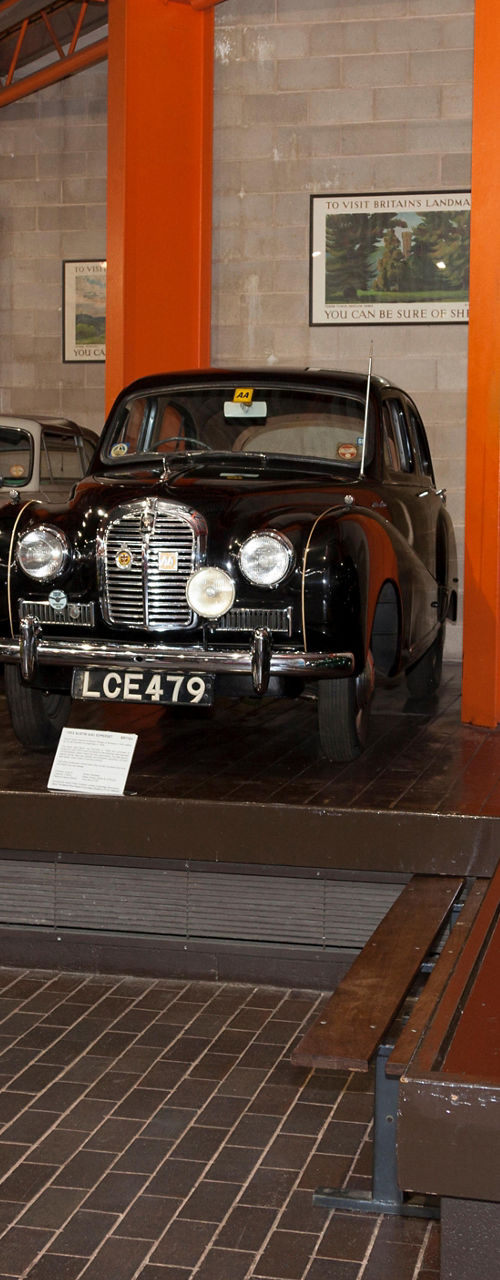 Vintage cars displayed in indoor museum