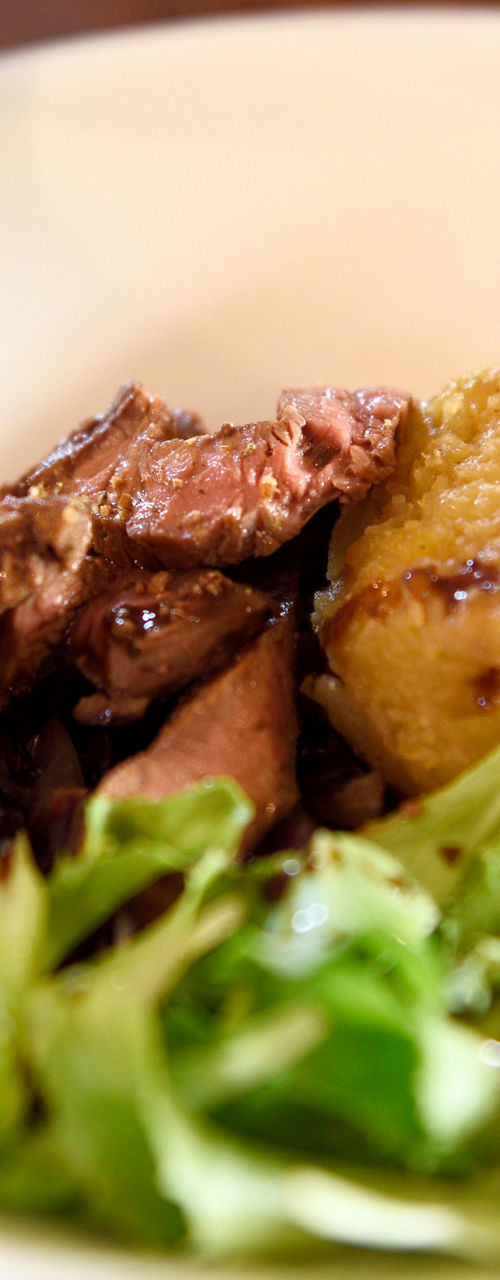 Gourmet steak dish with greens and sides