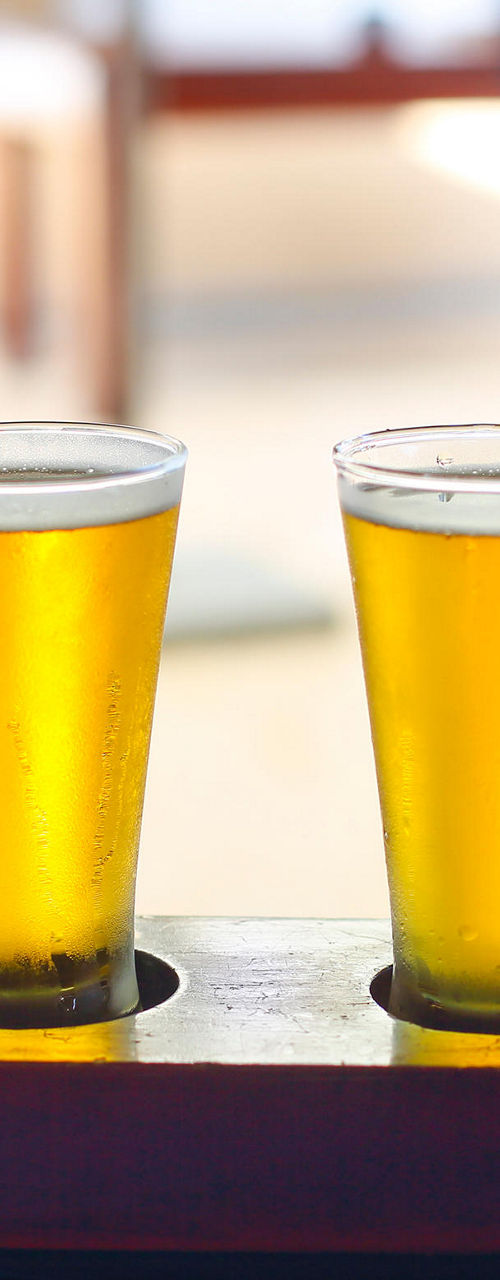 Beer flight with four glasses on table