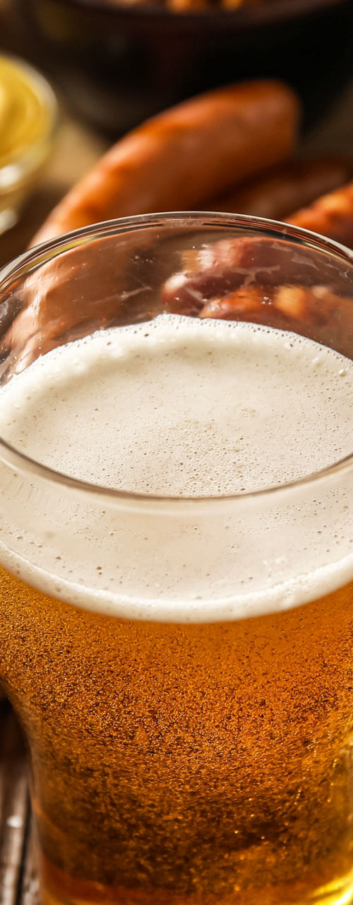 Beer glasses with pretzels and sausages