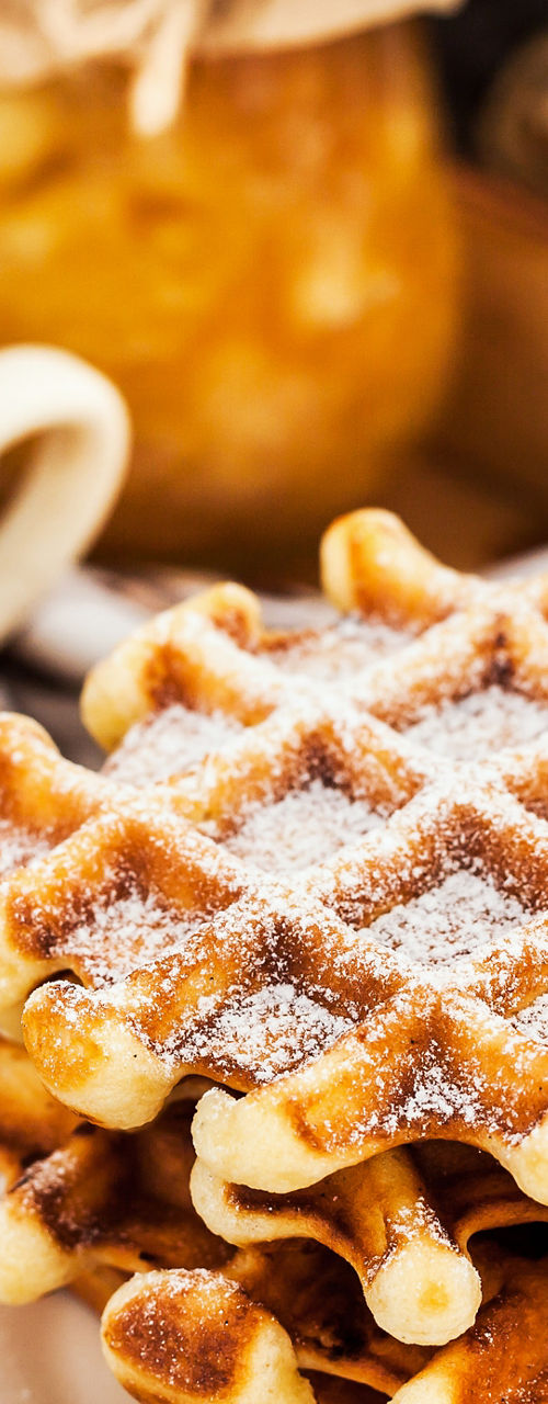 Fresh waffles with coffee on wooden tray