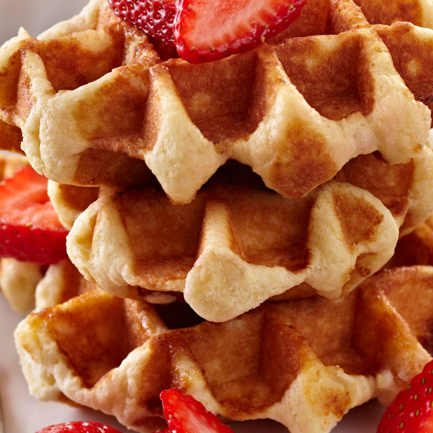 Stacked waffles with strawberries and coffee