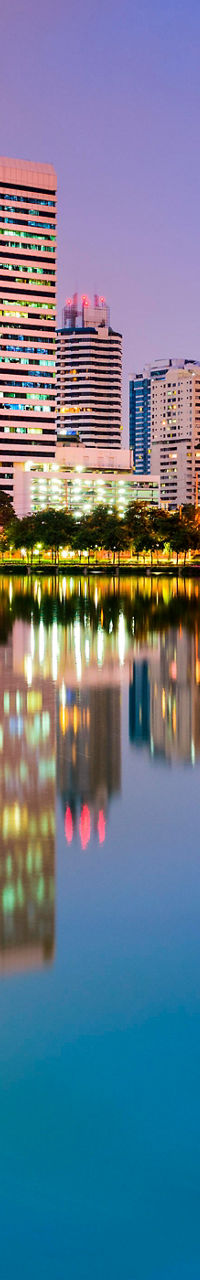 City skyline reflected in tranquil lake