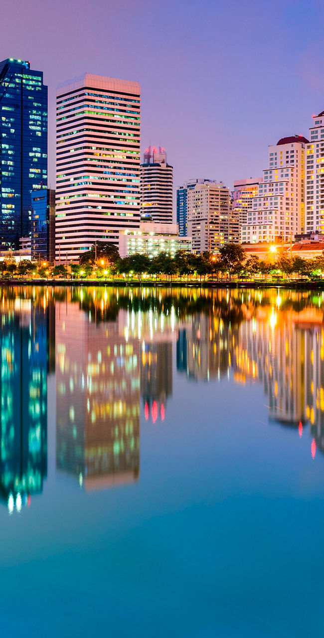 City skyline reflected in tranquil lake