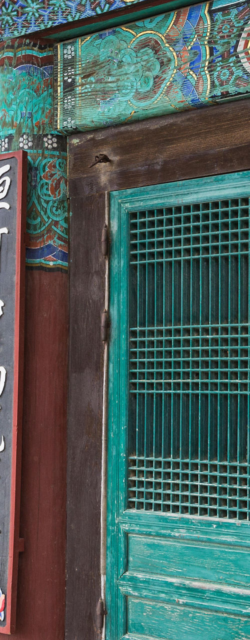 Traditional temple entrance with monk visible