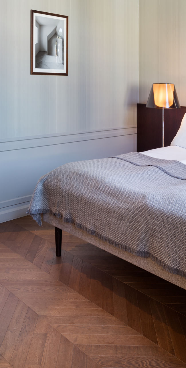 Modern hotel room with double bed and workspace