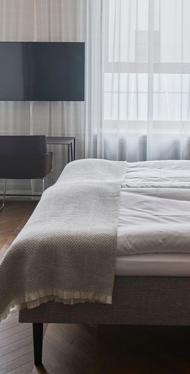 Modern hotel room with double bed and cozy decor