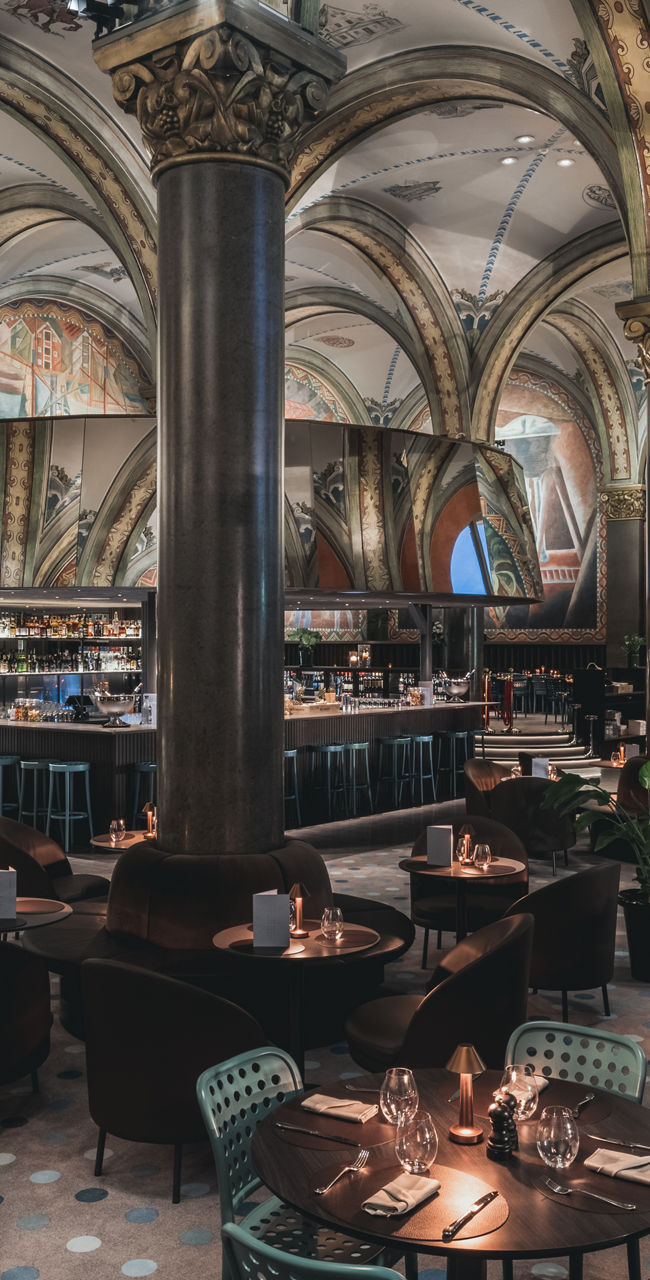 Elegant Restaurant Interior with Vaulted Ceilings and Murals